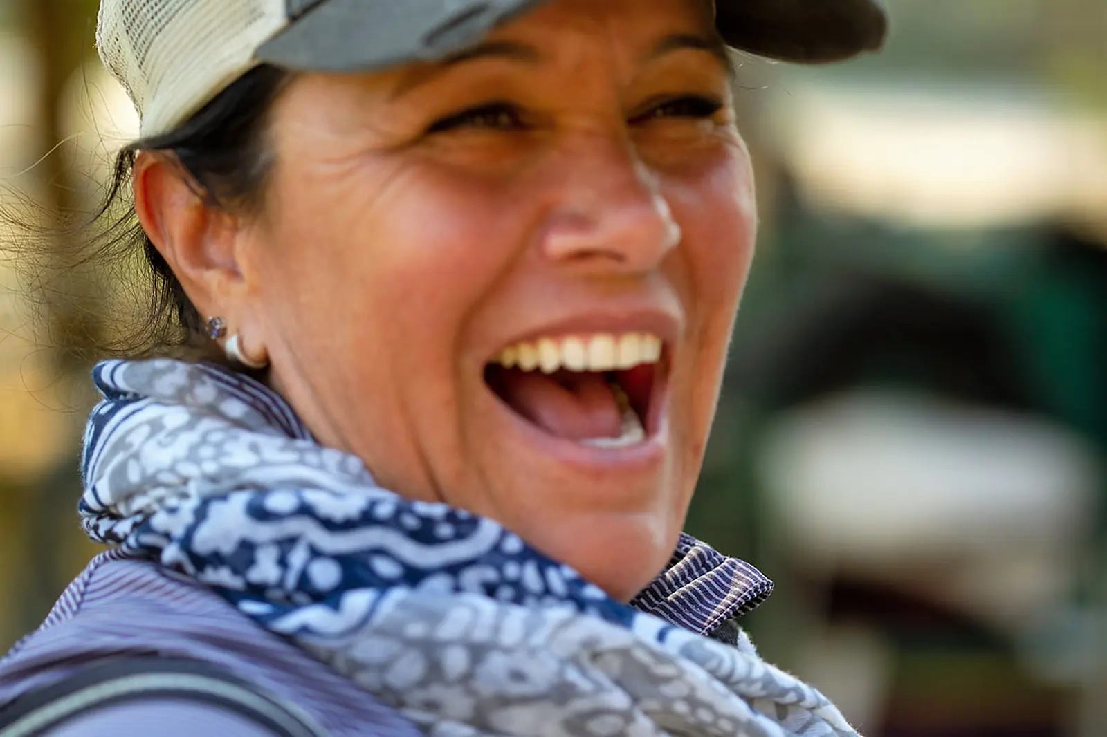 Tressa Boulden laughing, wearing a cap and scarf
